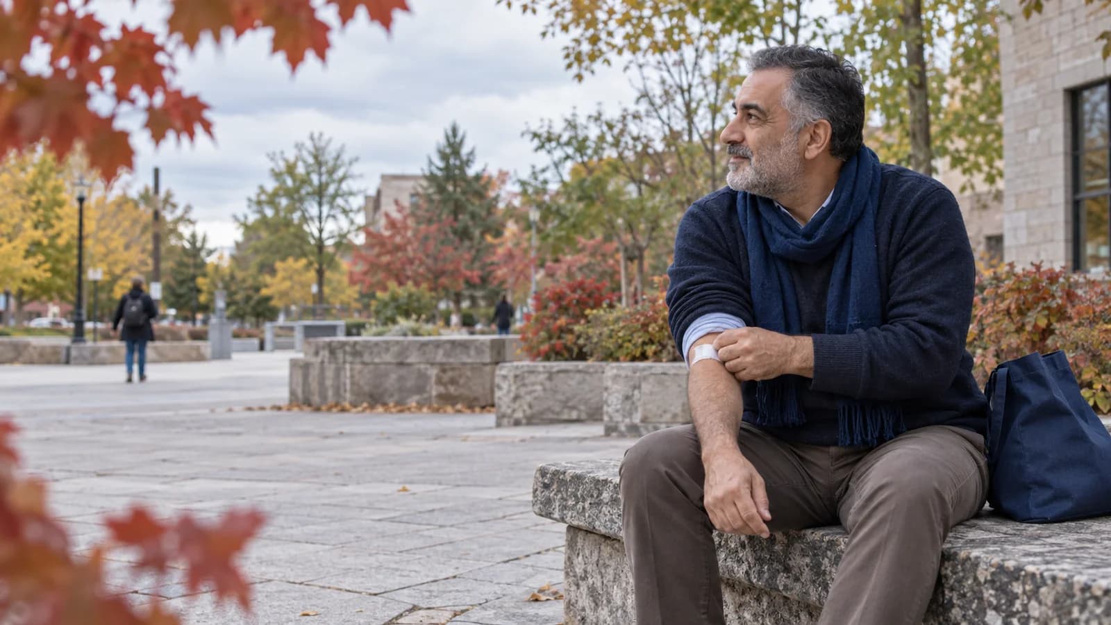 In an Ottawa civic square in early fall, a Middle Eastern Canadian man in his fifties in natural profile adjusts his sleeve over a small bandage after blood work.